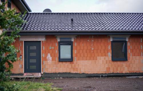 a red brick house with a black door and windows at Kelbergerly Hills in Kelberg