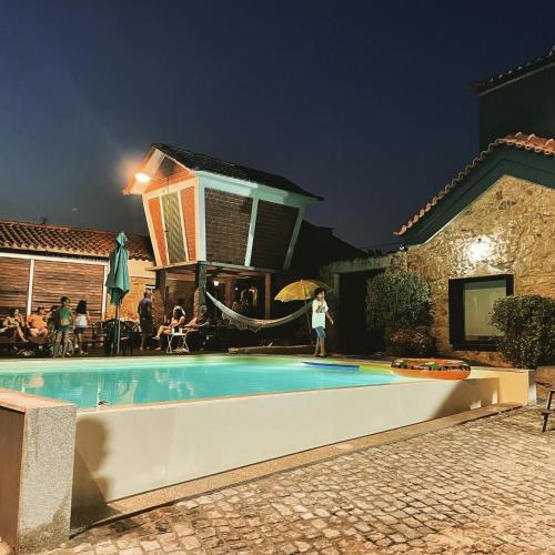 a swimming pool in a backyard at night at Quinta do Tojal - Tourism immersed in nature! in Vila Maior