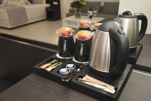 a tray with a coffee pot and cups on a kitchen counter at International Atene hotel in Athens