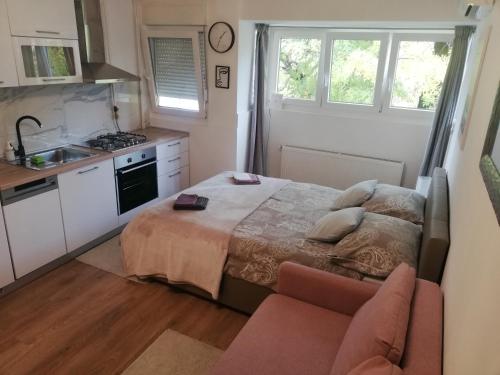 1 dormitorio pequeño con 1 cama y cocina en Studio apartman Jordanovac Rebro en Zagreb