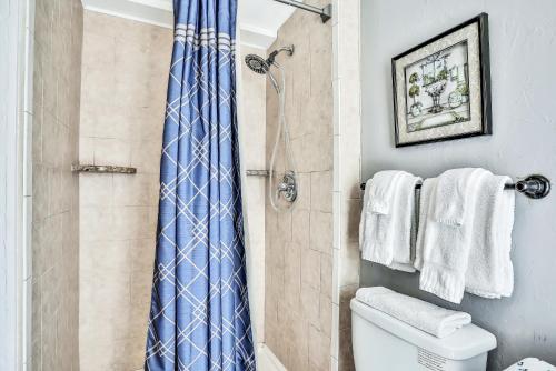 a bathroom with a shower with a blue shower curtain at The Landmark St Augustine in Saint Augustine