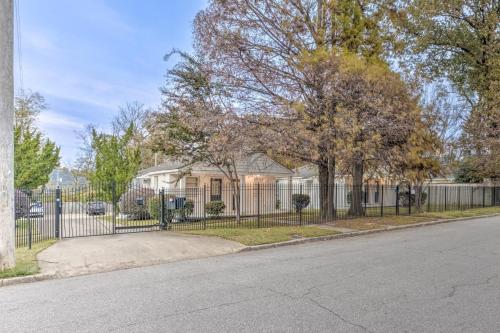 a fence in front of a house with trees at Gated Retreat Steps from Midtown's Best Parking in Memphis