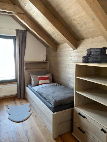 a small bedroom with a bed in a attic at VILLA BOHEMIA - Boží Dar in Boží Dar