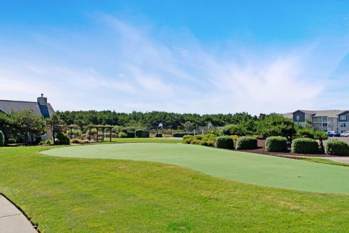 a view of a golf course with a green yard at Once Upon a Tide in Westport