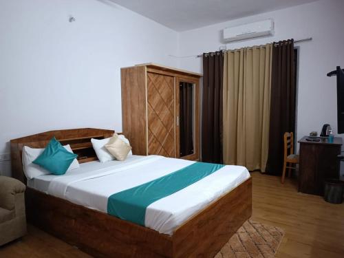 a bedroom with a bed and a desk in a room at Happy Stay Near Airport Pune in Pune
