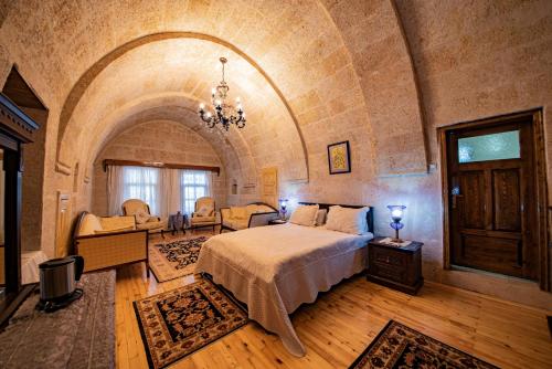 a bedroom with a bed in a room with an archway at Upper Greek House in Mustafapaşa