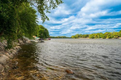 a view of a river with a boat on it at Manor on the River/Hot Tub/Pontoon/Jet Ski in Champlin
