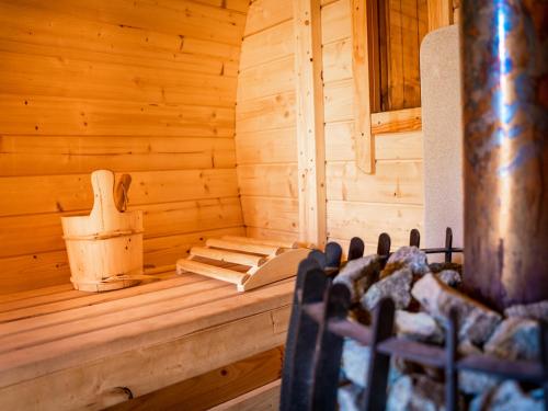 a wooden room with a sauna with a chair in it at Wikno Port in Wikno