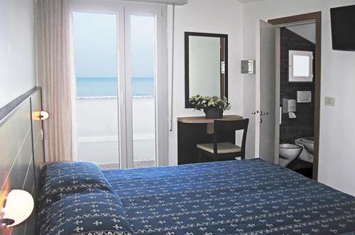 Postel nebo postele na pokoji v ubytování Hotel Sorriso - molto più di una stella