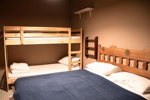 two bunk beds in a room with a blue bed at Grand Sauze Apartment-GestingHome in Sauze dʼOulx
