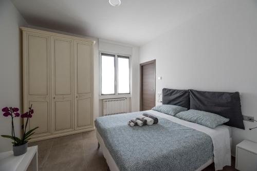 a bedroom with a bed with two stuffed animals on it at Villino Liber in Milan
