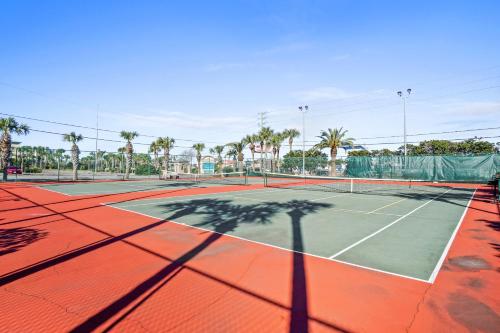 a tennis court with a shadow on the court at Emerald Towers by Panhandle Getaways in Destin