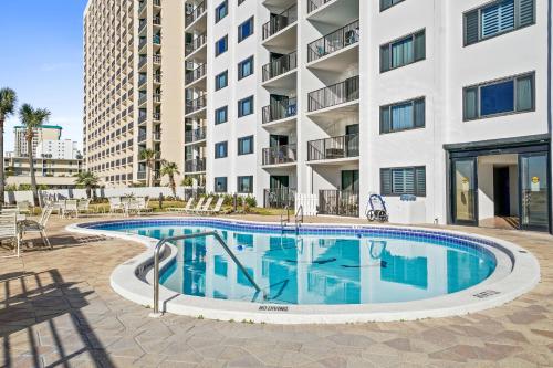 a swimming pool in front of a building at Emerald Towers by Panhandle Getaways in Destin