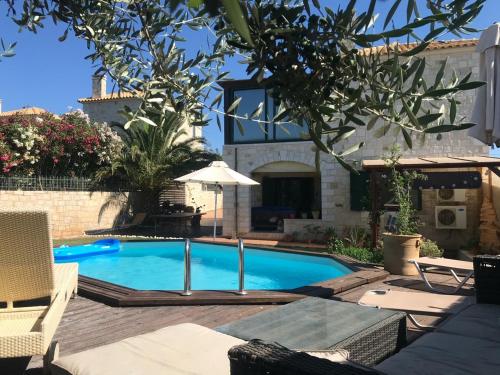 a swimming pool in the backyard of a house at Villa Pascale in Hersonissos