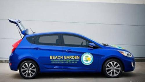 a blue car with a beach garden written on it at Kivu Beach Garden in Gisenyi