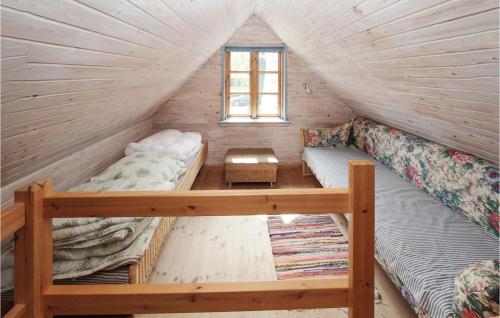 a room with two bunk beds in a wooden house at 1 Bedroom Amazing Apartment In Sams in Ballen