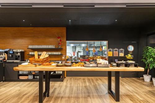 a bakery with a table with food on it at Mercure Namur Hotel in Namur