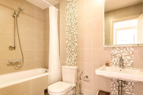 a bathroom with a toilet and a sink and a tub at Lavender Bay Apartments D3 or D5 in Donji Morinj