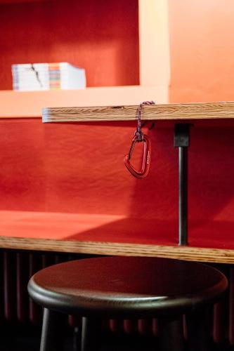 a black stool sitting under a counter with a wooden table at Garni Reider in Sesto