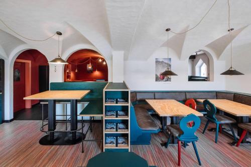 a restaurant with tables and chairs in a room at Garni Reider in Sesto