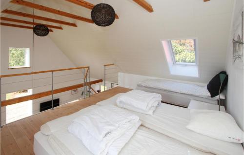 a white bedroom with a bed and two windows at Beautiful Apartment In Sams With Wifi in Ballen