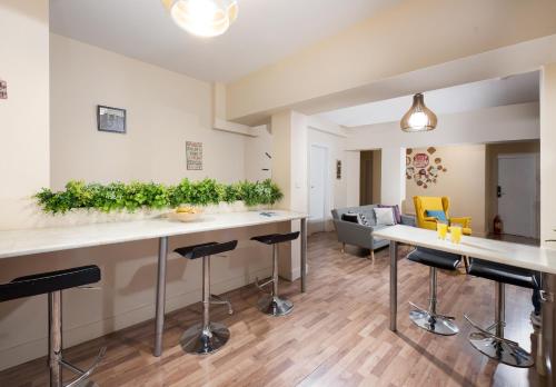 a kitchen and living room with bar stools at Enattica Syntagma Living in Athens