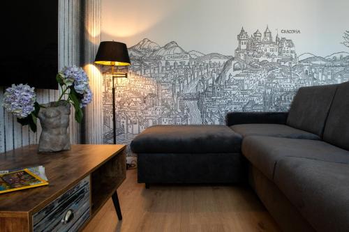a living room with a couch and a wall mural at InPoint Apartments G15 near Old Town & Kazimierz District & Optional Paid Parking in Kraków