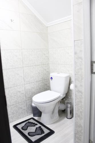 a bathroom with a white toilet in a room at Margo in Yaremche