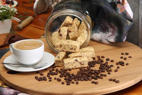 a plate of cookies and a cup of coffee at Del Roza Guest House in Middelburg
