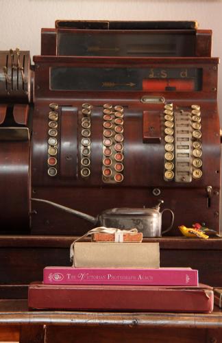 an old fashioned telephone sitting on a table with books at Del Roza Guest House in Middelburg