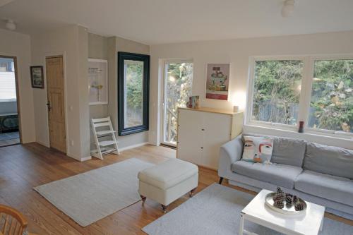 a living room with a couch and some windows at Nice summer house near the sea on Lidingo in Lidingö