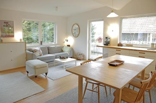 a kitchen and living room with a table and a couch at Nice summer house near the sea on Lidingo in Lidingö