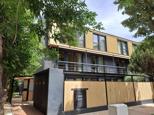 an apartment building with a fence in front of it at VIVERO 5 SMA in San Martín de los Andes