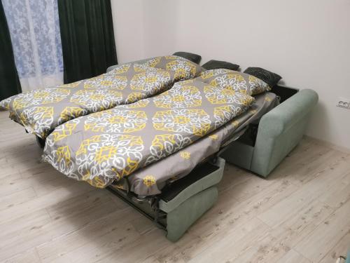 a bed with a blanket on top of it at Studio Oslo byPMM in Plovdiv