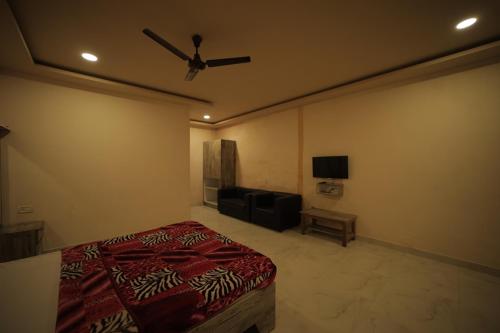 a bedroom with a bed and a flat screen tv at Green Park Resort in Masinagudi