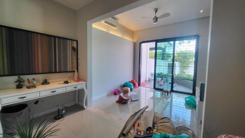 a living room with a child sitting on the floor at Fairy Retreat Pravite Pool Cottage - 10-12 pax in Ipoh