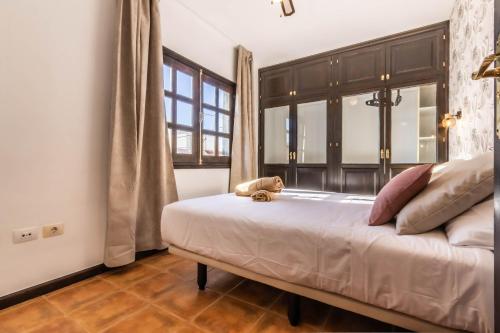a bedroom with a bed with a teddy bear on it at Hotel Ecolife Tenerife in San Miguel de Abona