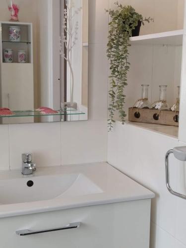 a white bathroom with a sink and a mirror at LA GRANDA DE LA CONCHA in Nueva de Llanes