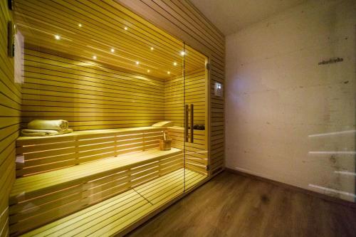 a sauna with a glass door and a wooden floor at Luxury Villa Loma 2 in Sveti Vid-Miholjice