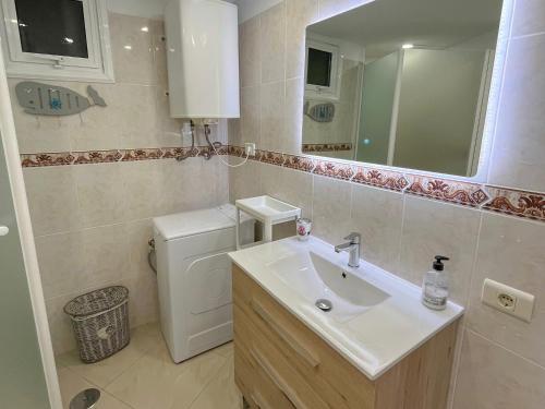 a bathroom with a sink and a toilet and a mirror at DREAMY SUNSET, SeaFront, Direct Access To The Promenade,Wifi,Free Parking in Los Cristianos
