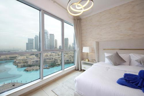 a bedroom with a large bed and a large window at New Arabian Burj Residence Downtown Dubai in Dubai