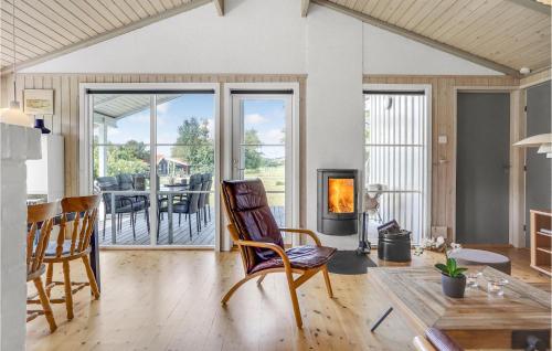 a living room with rocking chairs and a fireplace at Amazing Home In Ebeltoft With Four Bedrooms in Ebeltoft