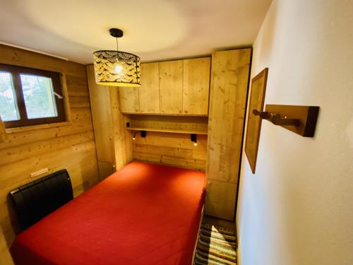 an empty hallway with a red carpet in a room at Chalet Jonquille in Valfréjus