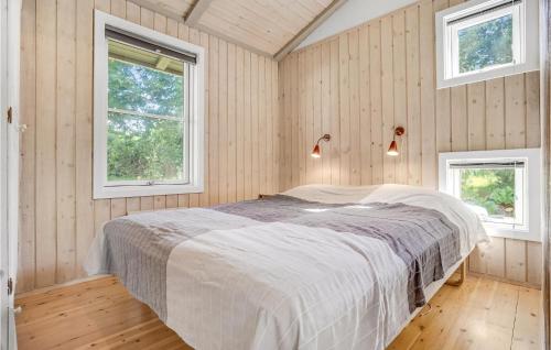 a bedroom with a bed in a room with two windows at Beautiful Home In Ebeltoft With Wifi in Ebeltoft