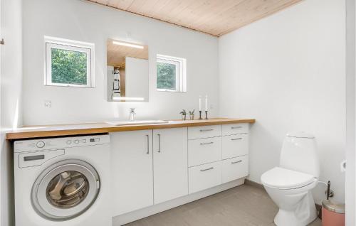 a white laundry room with a sink and a washing machine at Beautiful Home In Ebeltoft With Wifi in Ebeltoft