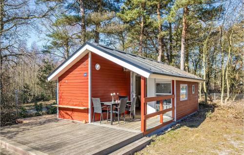 a small cabin with a table and chairs on a deck at A Stunning Home In Nexø With 1 Bedrooms And Wifi in Neksø