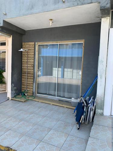 una habitación con ventana y una maleta en un patio en Apartamento itapirubá en Imbituba