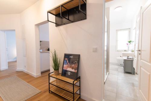 a living room with a staircase in a apartment at DWELLSTAY - Wohnung 90qm, 3 Schlafzimmer, Küche, Wohnzimmer, Balkon, Netflix in Fulda