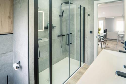 a bathroom with a shower with a glass door at APARTAMENTO PEDRADOURO in Malpica