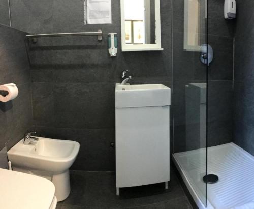 a bathroom with a sink and a toilet and a shower at Hotel Convertini in Milan